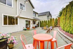 a patio with a wooden table and chairs at Spacious Kent Home Near SeaTac Airport with Patio in Kent