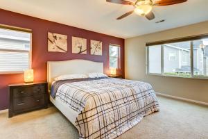 a bedroom with a bed and a ceiling fan at Spacious Kent Home Near SeaTac Airport with Patio in Kent