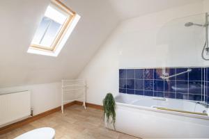 a bathroom with a bath tub and a window at Somersal Cottages in Ashbourne +169 photos