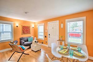 a living room with a table and chairs and a couch at Colorful Long Beach Bungalow with Patio and Grill in Long Beach
