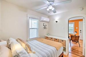 a bedroom with a bed and a ceiling fan at Colorful Long Beach Bungalow with Patio and Grill in Long Beach