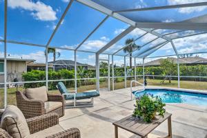 een patio met een zwembad en een glazen serre bij 6 Mi to Dtwn Cape Coral Home with Spacious Lanai! in Cape Coral