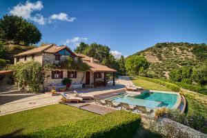 a villa with a swimming pool and a house at Wild Oak Estate - Stone Villa with Sea Views , by ZanteWize in Argassi