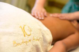 a woman is sitting on a pillow with her panties at 10GR Boutique Hotel & Wine Bar in Rhodes Town