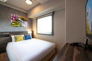 a bedroom with a large white bed and a window at Just Sleep Osaka Shinsaibashi in Osaka +28 photos
