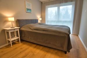 a bedroom with a bed and a table and a window at Vacation Home in Prater - Central, Garden and Sauna in Vienna