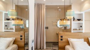 a bedroom with two beds and two chandeliers at Briki Suites in Kallithea Halkidikis +29 photos