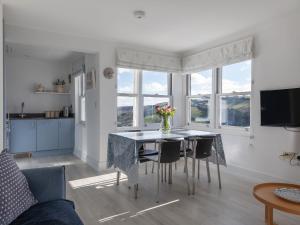 a kitchen and living room with a table and chairs at 4 Blue View in Salcombe