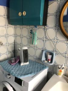 a bathroom with a drying rack on the sink at Casa Patrizia in Villapiana