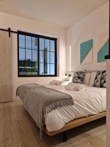 a bedroom with a large bed with a large window at Apartamentos WUR in Madrid