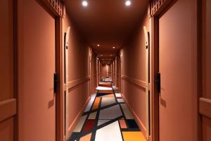 an empty corridor with a long corridor at La Folie Douce Hotels Chamonix in Chamonix