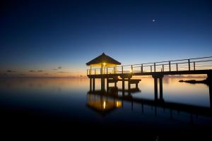 a pier on the water at night at Maitai Rangiroa in Avatoru +37 photos
