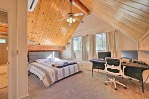 a bedroom with a bed and a desk with a computer at Pine Mountain Lake Cabin w/ Grill! in Groveland