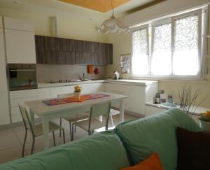 a kitchen with a table and a table and a couch at Casa LorEn in Pesaro