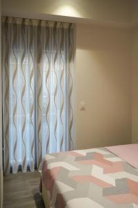a bedroom with a bed and a window with curtains at Mimi's Apartment in En Corts in Valencia