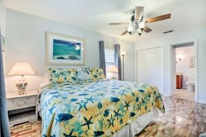 a bedroom with a bed and a ceiling fan at St Augustine Island Home with Patio, Walk to Beach! in Saint Augustine