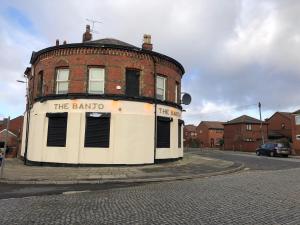 a round brick building with the bando written on it at The Banjo Guesthouse in Liverpool