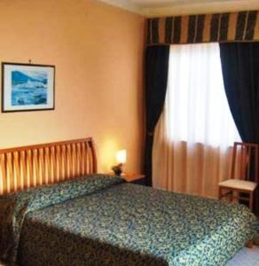 Postel nebo postele na pokoji v ubytování Hotel Miramare