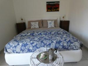 a bedroom with a bed with a glass table next to it at Casa LorEn in Pesaro