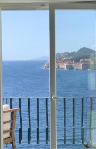 a view of the ocean from a balcony at Beach house Sveti Jakov in Dubrovnik