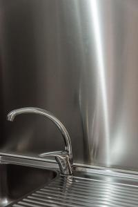 a stainless steel sink with a chrome faucet at A casa di Rocco in Castel di Sangro