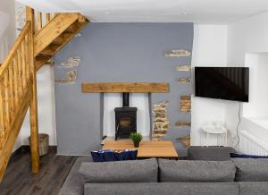 a living room with a couch and a fireplace at Shannon Castle Holiday Cottages Type C 