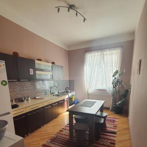 a small kitchen with a table and a table sidx sidx sidx at Guesthouse Hillside in Tbilisi City