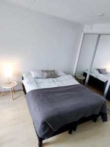 una camera con letto e tavolo con lampada di Alvar, Tilava uusi kaksio ydinkeskustassa 53 m2 a Jyväskylä