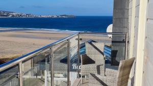 a balcony with a view of the beach at Sandy Bay Apartment, St Ives Bay, Hayle in Hayle