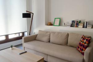 a living room with a couch and a coffee table at Sirokos House in Agios Ioannis Pelio