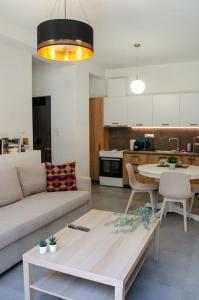 a living room with a couch and a table at Sirokos House in Agios Ioannis Pelio