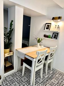 a dining room with a table and two chairs at GREEN Apartment in Riga