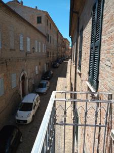 an alley with cars parked on the side of a building at ai18diamanti in Saludecio