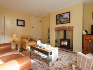 a living room with a couch and a fireplace at Bodkin Cottage in Minehead