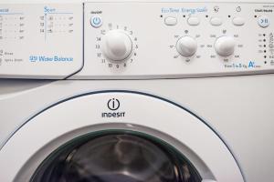 a washing machine is shown with the door open at Modern Apartment Riegrovy sady in Prague