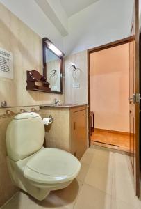 a bathroom with a toilet and a sink at Reds Residency - Homestay in Cochin