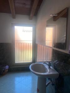 a bathroom with a sink and a mirror and a window at MRHostel Milano in Milan