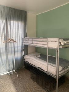 two bunk beds in a room with a window at MRHostel Milano in Milan