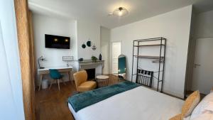 a bedroom with a bed and a desk at Jardin Bleu - Chambres d'hôtes in Saint-Girons