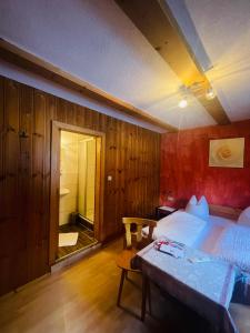 a bedroom with a bed and a table in it at Pension Bucher in Schnann