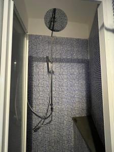 a shower in a bathroom with a shower head at La Casa di Litz in Naples