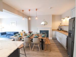 a kitchen and dining room with a table and chairs at Tan Y Fron in Penrhyn Bay
