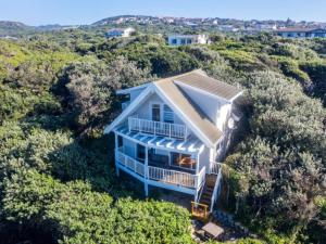 an aerial view of a house on a hill with trees at The Spinning Reel Beach Cottages in Port Alfred
