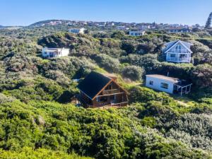 a house on top of a hill with houses at The Spinning Reel Beach Cottages in Port Alfred