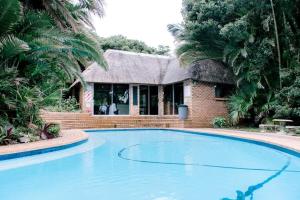 a house with a swimming pool in front of a house at Carisford Creek in Clansthal