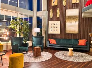 a lobby with chairs and a couch and a table at Atrium Hotel Amadeus in Osterfeld