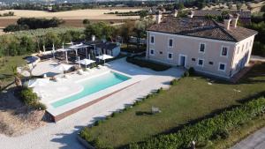 an aerial view of a house with a swimming pool at Villa Montefiore Country Resort in Borghetto