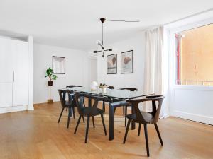 a dining room with a black table and chairs at Sanders City - Pleasant Four-Bedroom Apartment In the Lovely Capital in Copenhagen