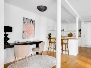a kitchen and dining room with a table and chairs at Sanders City - Pleasant Four-Bedroom Apartment In the Lovely Capital in Copenhagen