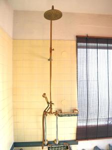 a shower in the corner of a bathroom at Yufuin Wasaku in Yufuin